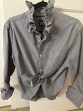 Millie is a light gray oxford shirt witha ruffled collar