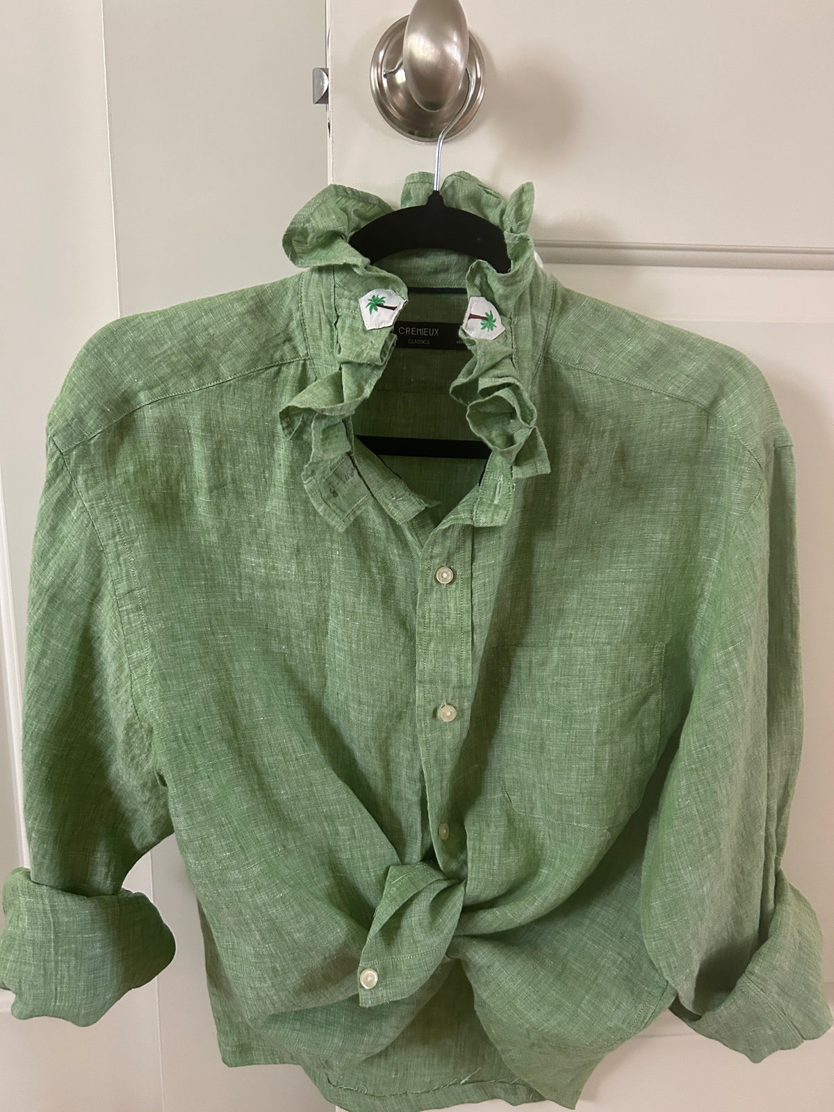 Sage green linen ruffled collar top on hanger with front knot detail