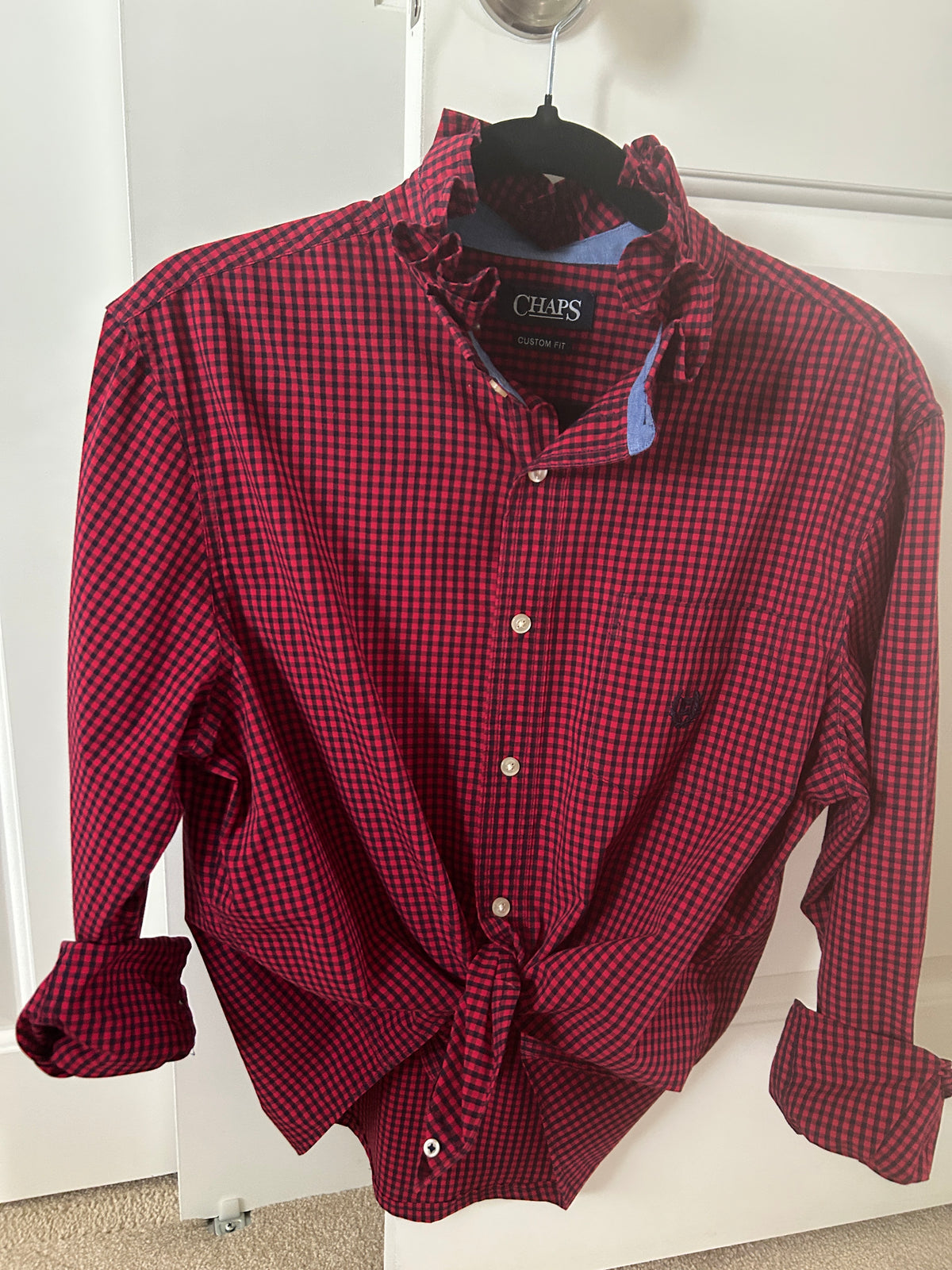 Ali, the long sleeve red and navy gingham shirt with a ruffled collar