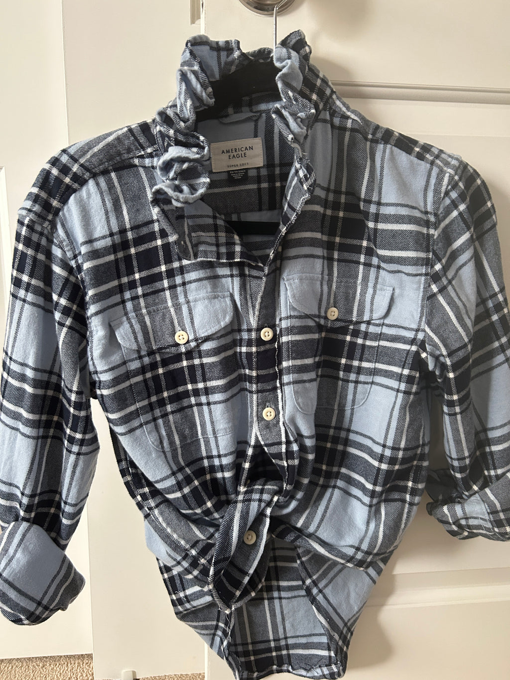 Ali gray and black plaid long-sleeve shirt with ruffled collar and two buttoned chest pockets