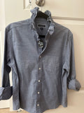Kim is a light blue oxford shirt with a beautiful ruffled collar